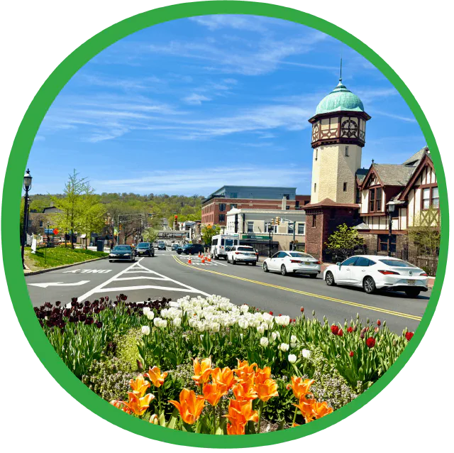 The clock tower in South Orange village centre, with tulips blooming along the roadside.
