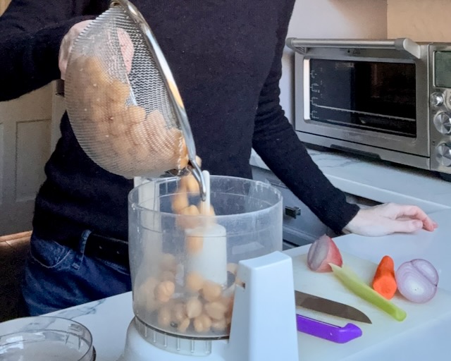 Chickpeas are poured into a small food processor
